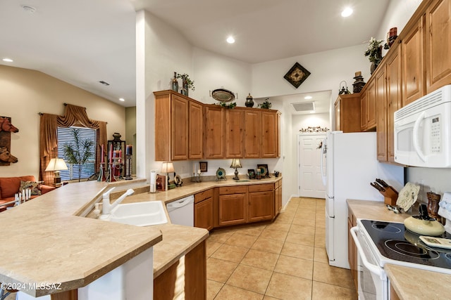 kitchen with kitchen peninsula, white appliances, sink, light tile patterned floors, and lofted ceiling