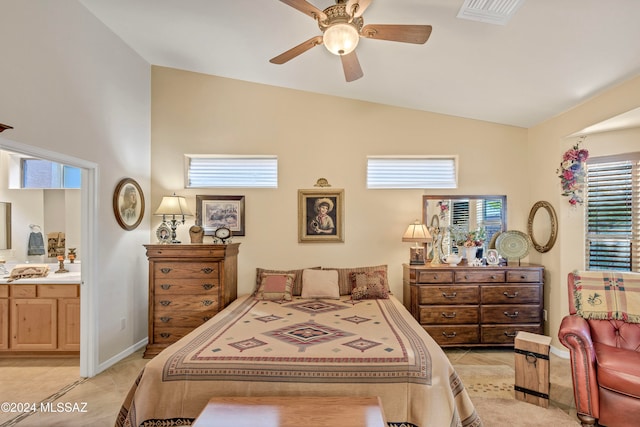 bedroom with ceiling fan, light tile patterned floors, ensuite bathroom, and lofted ceiling