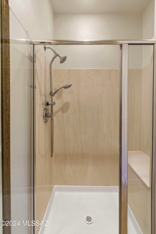 bathroom featuring a shower with door