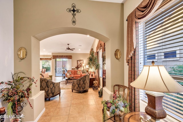 tiled living room featuring ceiling fan