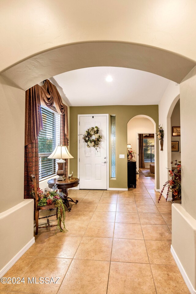 foyer entrance with light tile patterned flooring