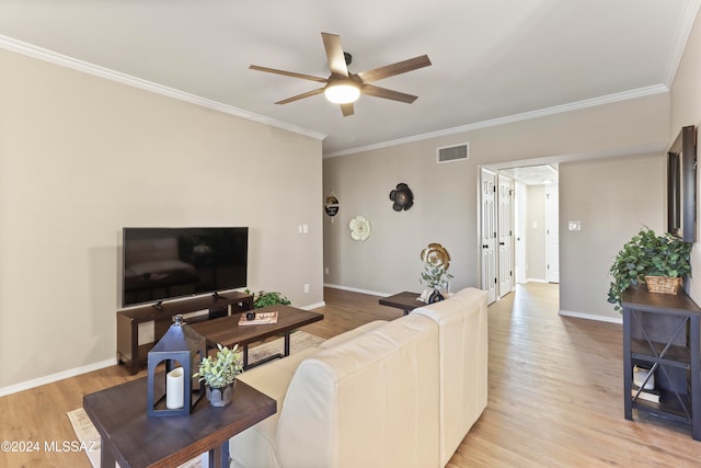 living room with light wood-type flooring, ceiling fan, and crown molding