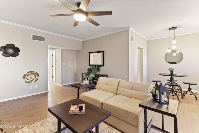 living room with light hardwood / wood-style floors, ceiling fan, and crown molding