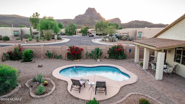 view of pool featuring a mountain view and a patio