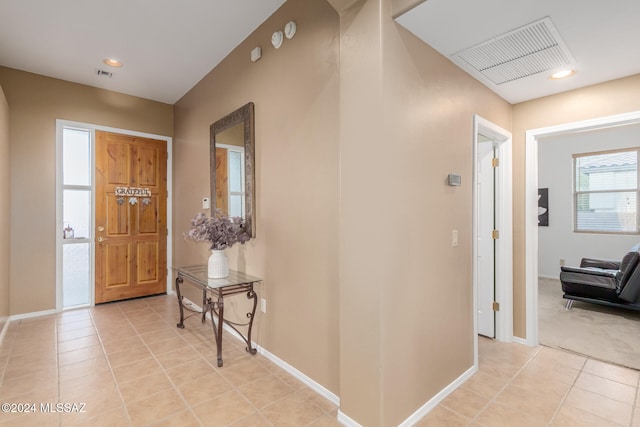 entryway with light tile patterned flooring