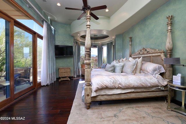 bedroom featuring access to exterior, dark hardwood / wood-style floors, multiple windows, and ceiling fan