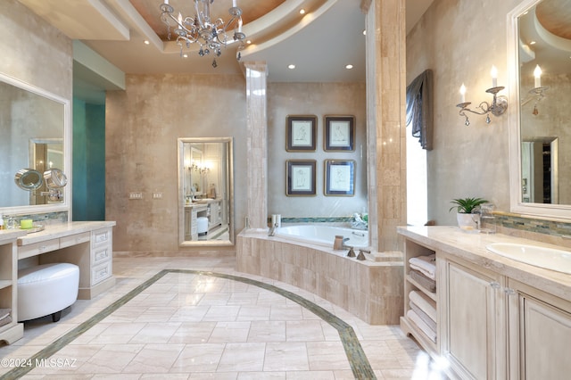 bathroom with vanity, a high ceiling, an inviting chandelier, a relaxing tiled tub, and a tray ceiling