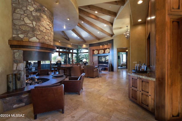 living room featuring beamed ceiling, high vaulted ceiling, and an inviting chandelier