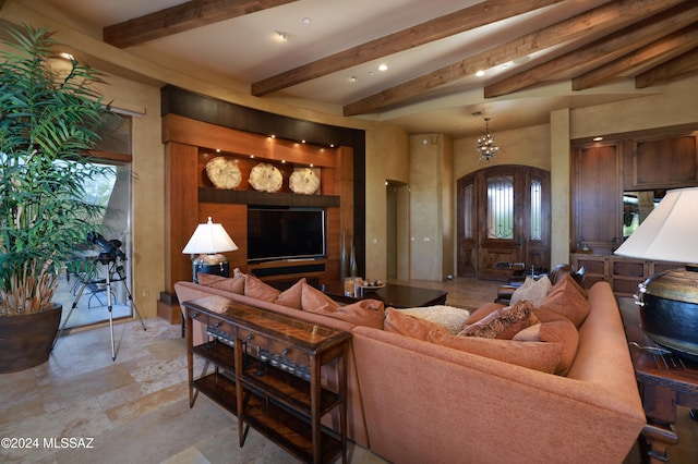 living room featuring beam ceiling and a healthy amount of sunlight