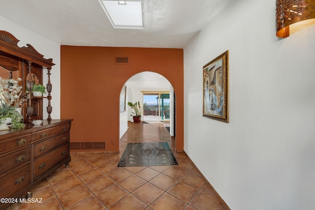 corridor featuring light tile patterned floors