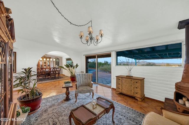 tiled living room featuring a chandelier