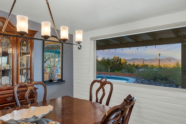 dining room featuring a mountain view and a chandelier