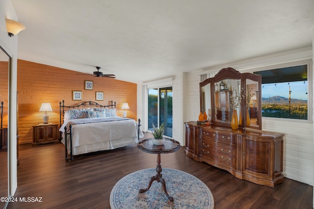 bedroom featuring dark hardwood / wood-style floors, ceiling fan, lofted ceiling, and access to outside