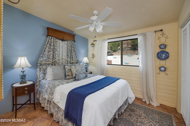 tiled bedroom with a closet and ceiling fan