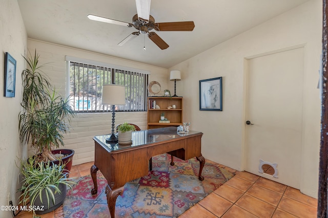 office area with light tile patterned floors, ceiling fan, and lofted ceiling