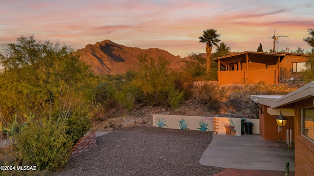 yard at dusk featuring a mountain view