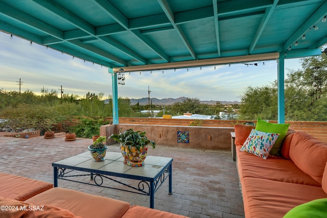 view of patio featuring a mountain view and an outdoor living space