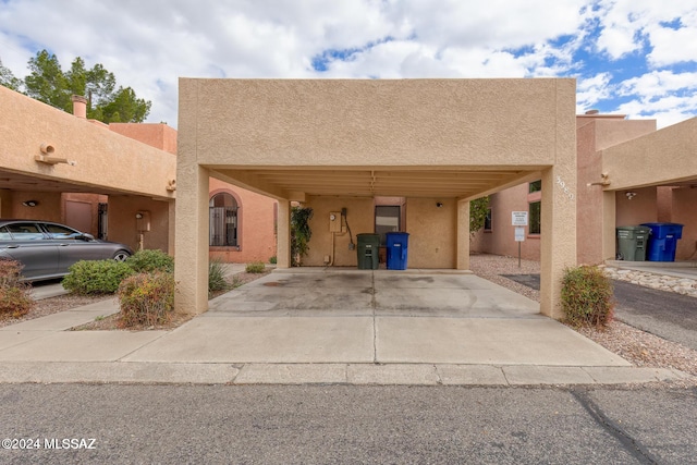 pueblo-style home featuring a carport