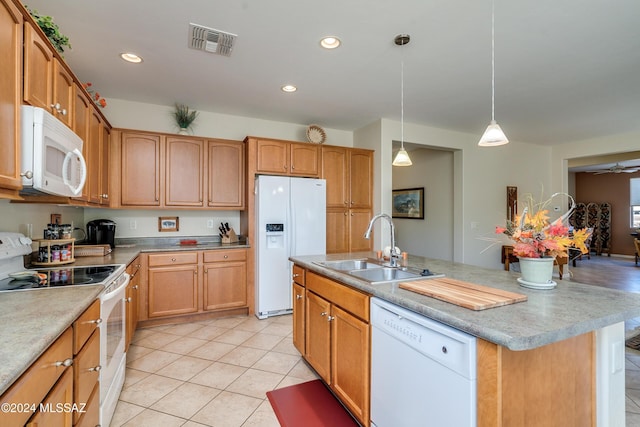 kitchen featuring white appliances, sink, an island with sink, decorative light fixtures, and light tile patterned flooring