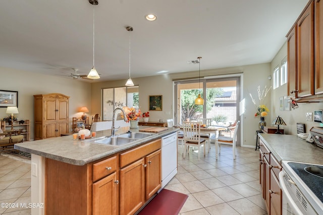 kitchen featuring pendant lighting, a center island with sink, white dishwasher, sink, and ceiling fan