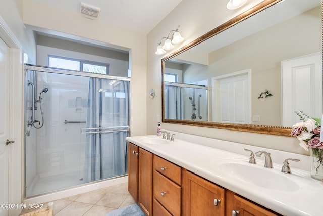 bathroom featuring tile patterned flooring, vanity, and an enclosed shower