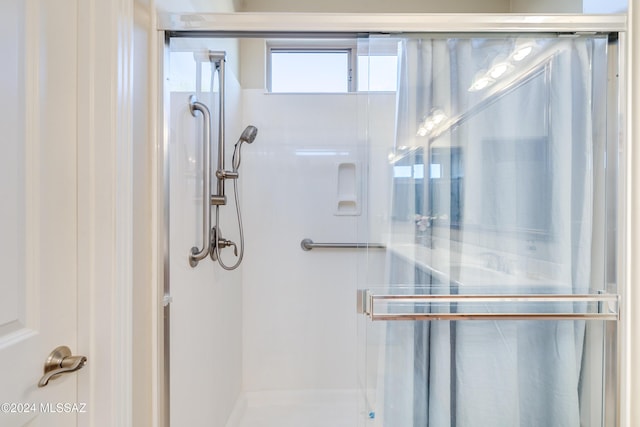 bathroom featuring a shower with door