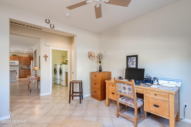 office space featuring light tile patterned floors, separate washer and dryer, and ceiling fan