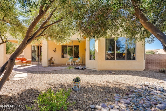 rear view of property featuring a patio