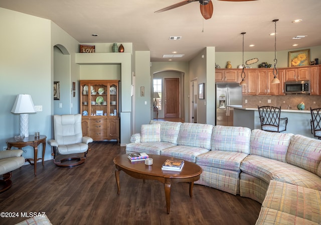 living room with ceiling fan and dark wood-type flooring