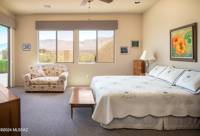 bedroom featuring carpet flooring, access to exterior, a mountain view, and ceiling fan