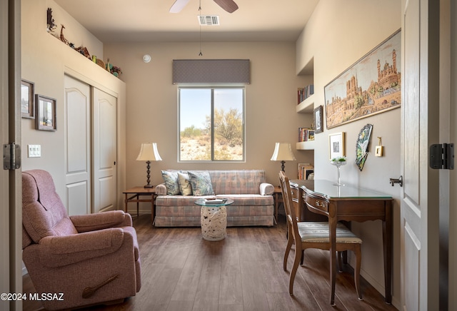 living room featuring hardwood / wood-style floors and ceiling fan