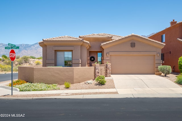 view of front of property with a mountain view and a garage