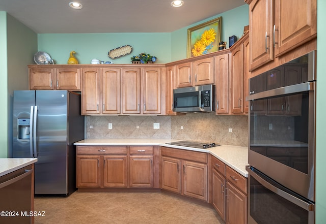 kitchen featuring decorative backsplash, light tile patterned floors, and stainless steel appliances