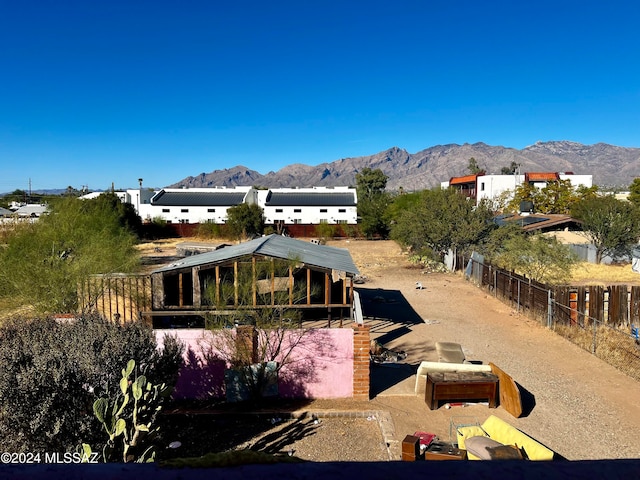 rear view of house featuring a mountain view