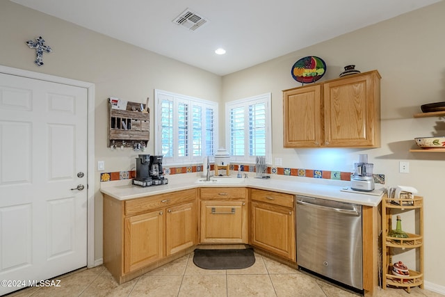 kitchen with dishwasher, light tile patterned floors, and sink