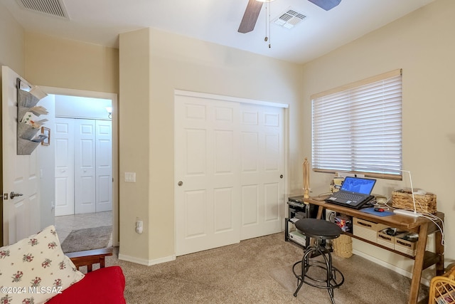 office area featuring light carpet and ceiling fan