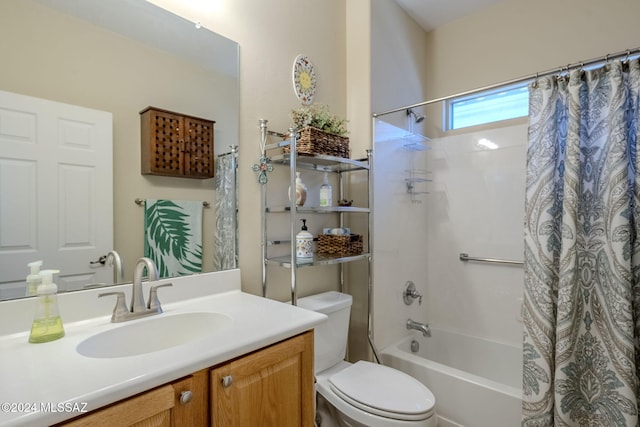 full bathroom with vanity, shower / tub combo, and toilet