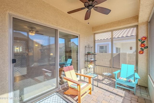 sunroom featuring ceiling fan