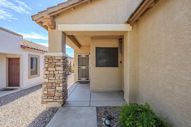 property entrance with a patio