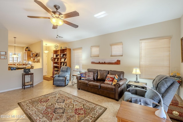 living room featuring ceiling fan and light tile patterned flooring