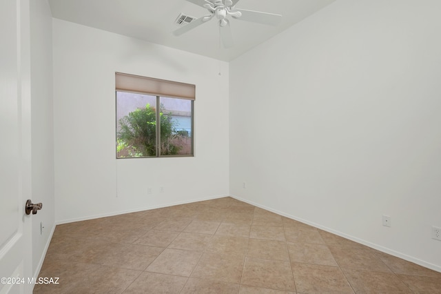 tiled empty room with ceiling fan