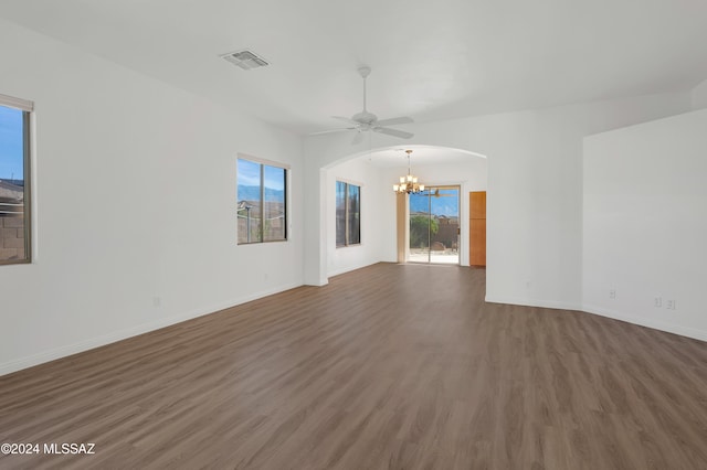 empty room featuring dark hardwood / wood-style floors and ceiling fan with notable chandelier