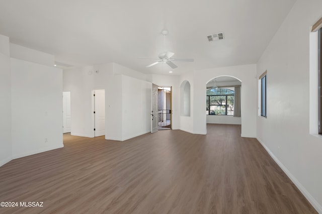 unfurnished living room featuring dark hardwood / wood-style flooring and ceiling fan