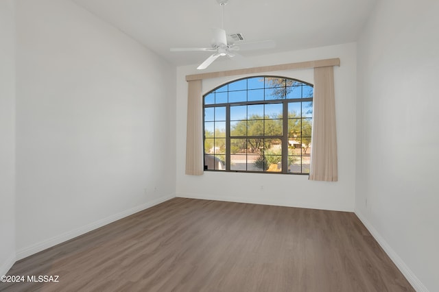 spare room with ceiling fan and dark wood-type flooring