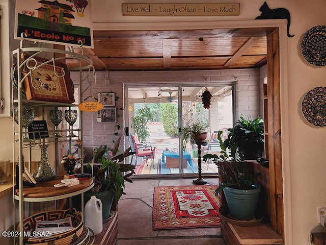 interior space featuring carpet floors and wooden ceiling