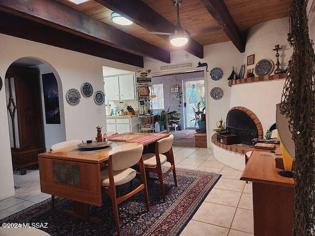 tiled dining space with beam ceiling and wooden ceiling