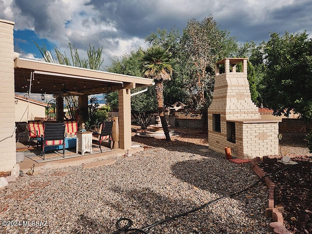 view of yard with a fireplace and a patio