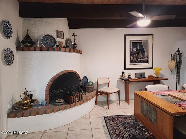 living room with ceiling fan, beamed ceiling, light tile patterned flooring, and wooden ceiling