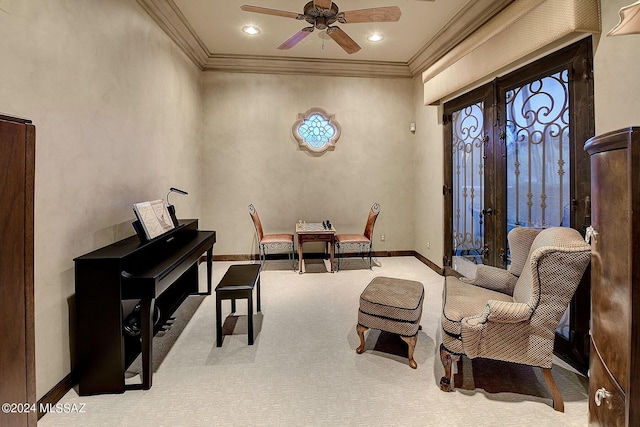 living area with french doors, ceiling fan, ornamental molding, and light carpet