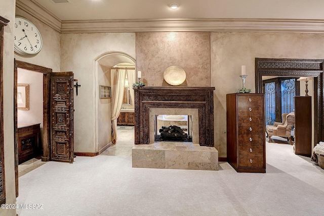 carpeted living room featuring crown molding and a fireplace